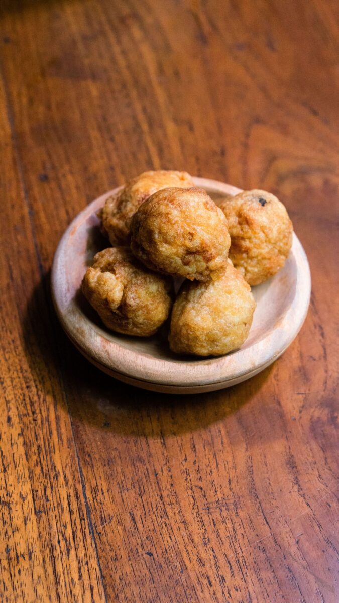 A plate of traditional Indonesian fried meatballs served on a wooden table.